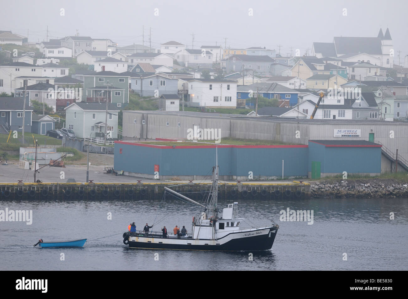 Fishermen in boat returning to Port aux Basques Newfoundland harbour at