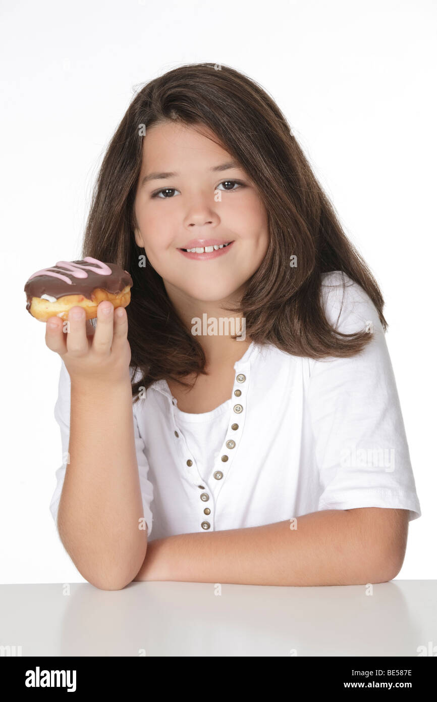 Cute Caucasian girl eating a donut on a white background Stock Photo