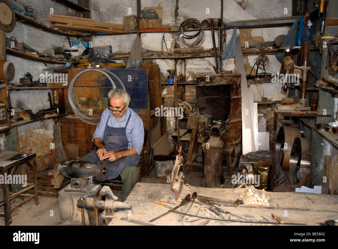 Old craftsman in his knife grinder, mountain village of Agiassos, Lesbos, Aegean Sea