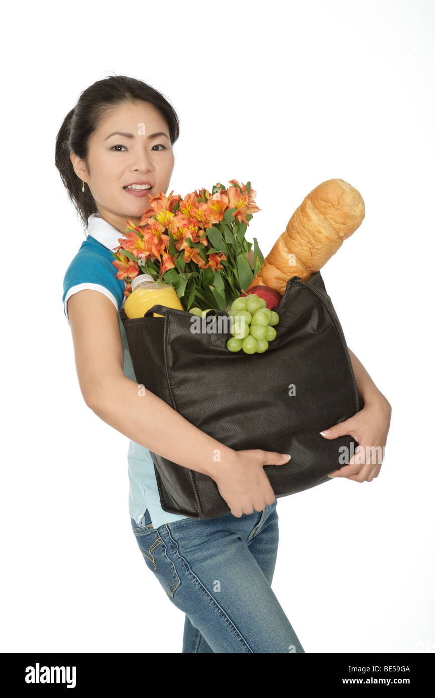 Beautiful Asian woman carrying a bag of groceries Stock Photo Alamy