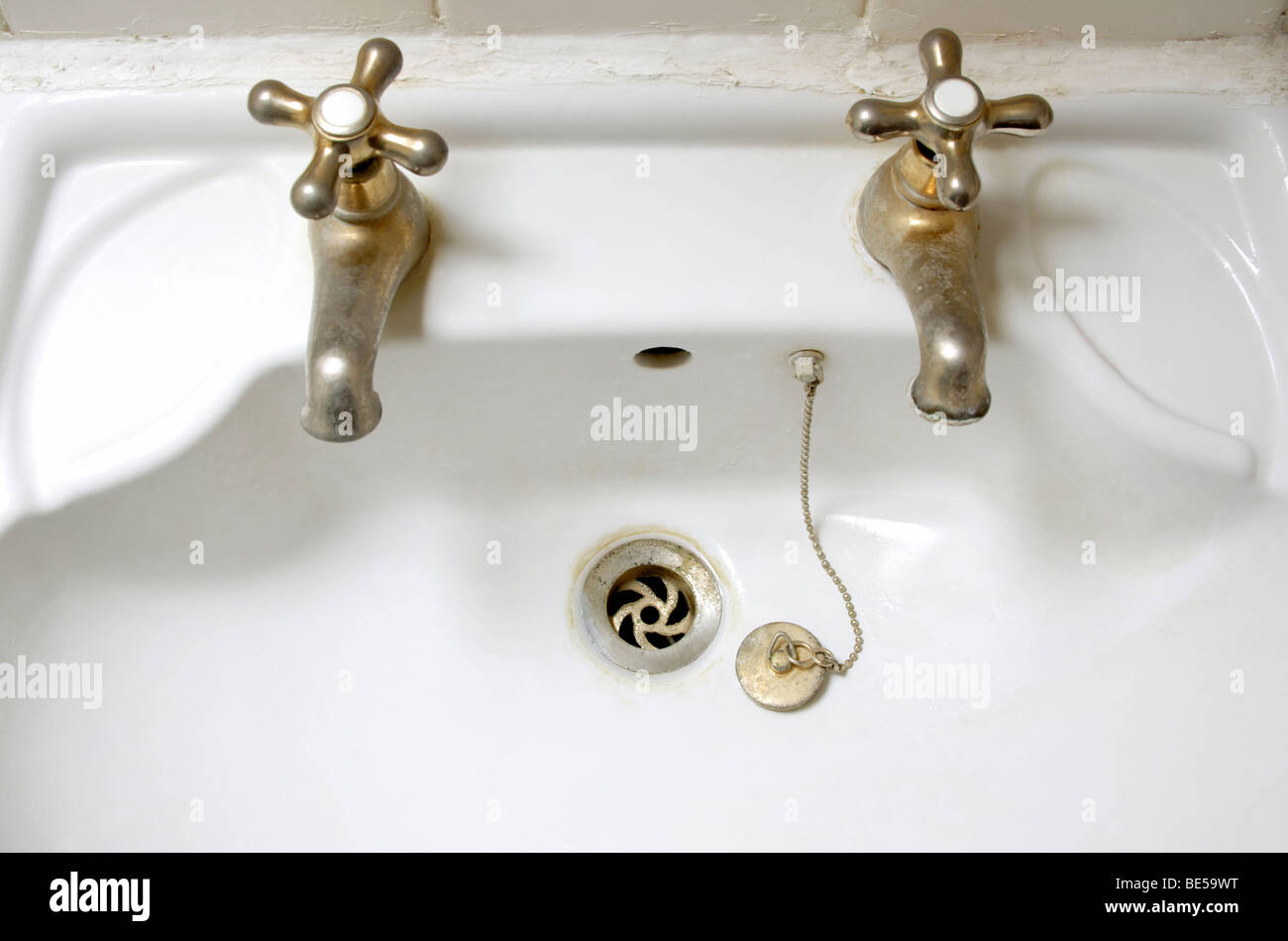 Empty bathroom sink with taps and plug Stock Photo