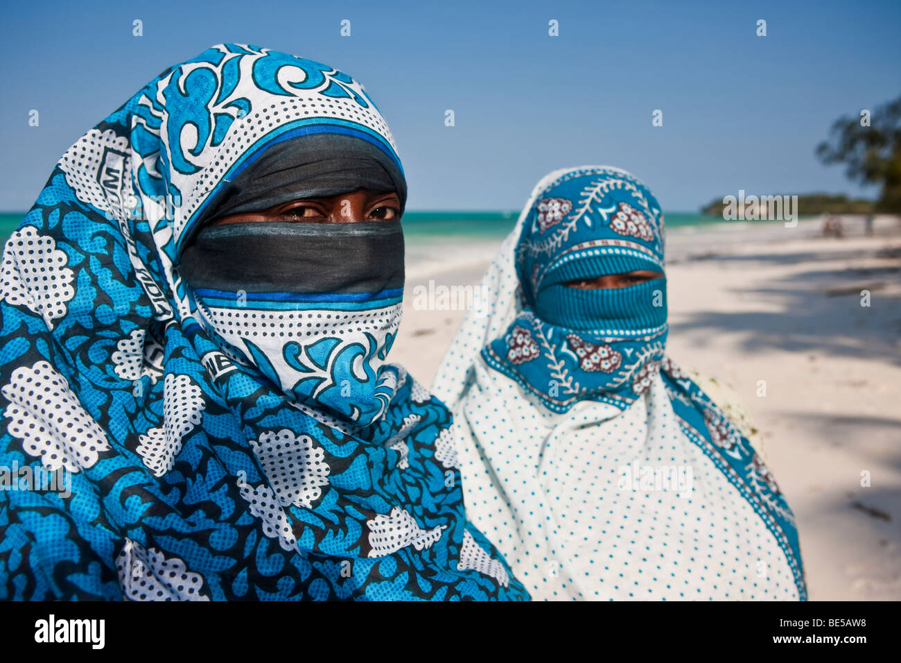 Veiled Muslim women on the beach in Zanzibar, Tanzania, Africa Stock Photo
