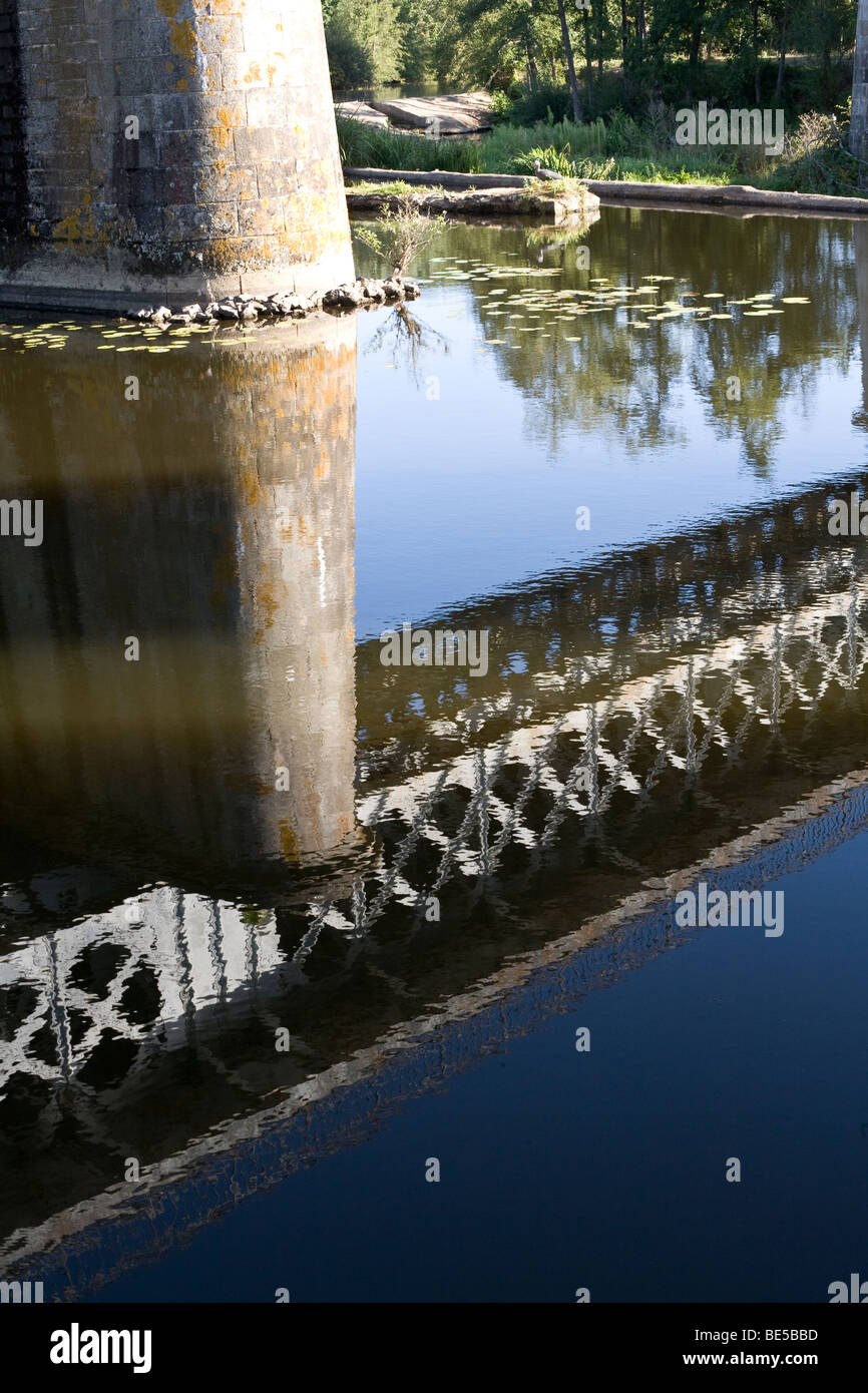 Reflection in river of railway bridge at Saint Loup sur Thouet, Gatine, Western France August 2009 Stock Photo
