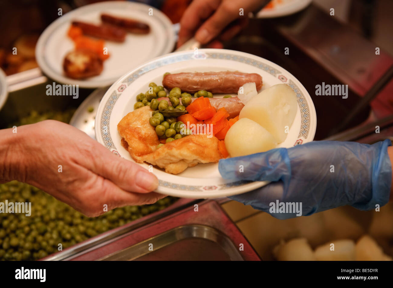 Serving hot School dinners in a primary school canteen, Wales UK Stock Photo