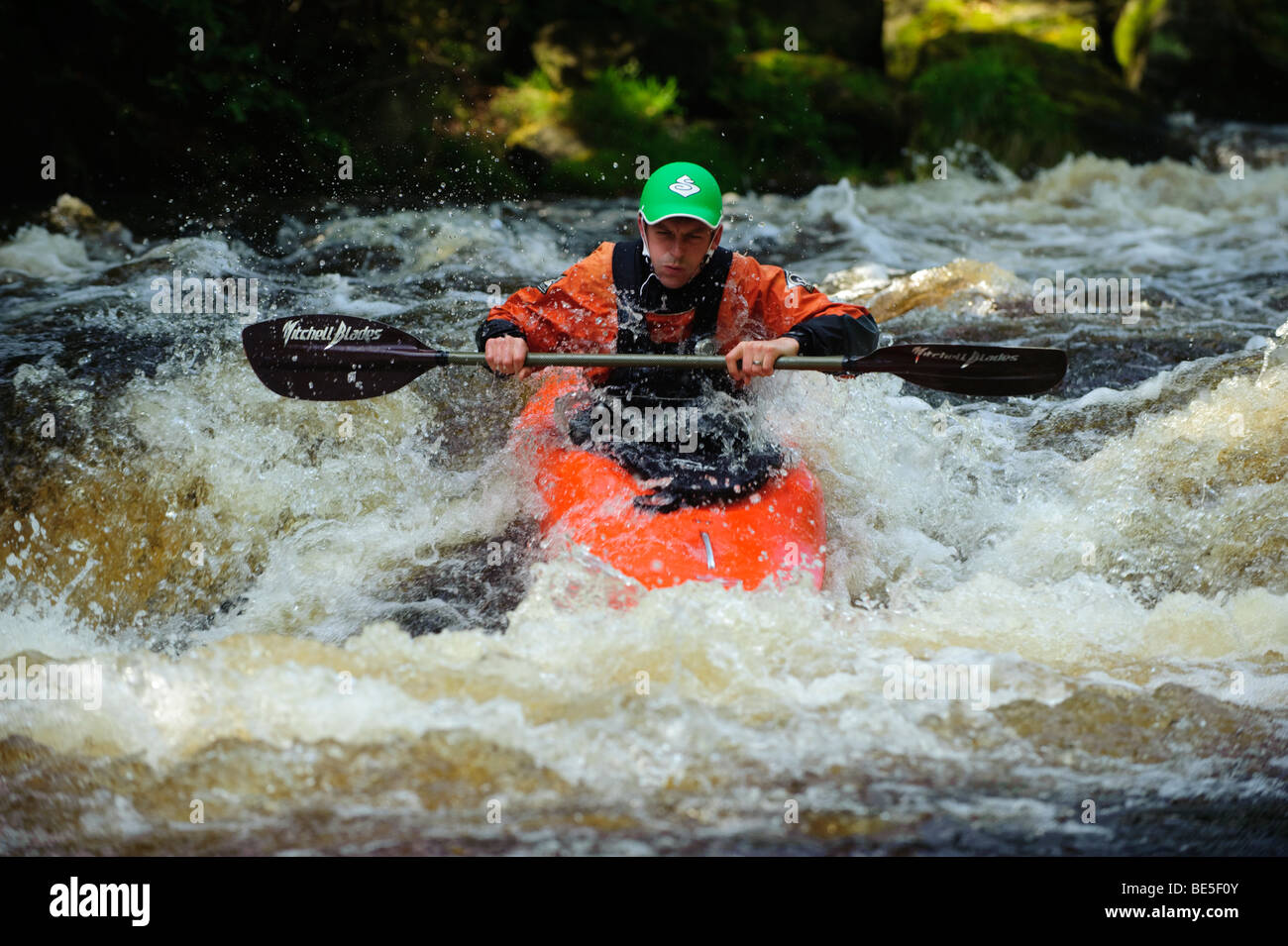 A person kayaking on the Tryweryn river, National White Water Centre, canoing watersports near Bala Gwynedd north wales UK Stock Photo