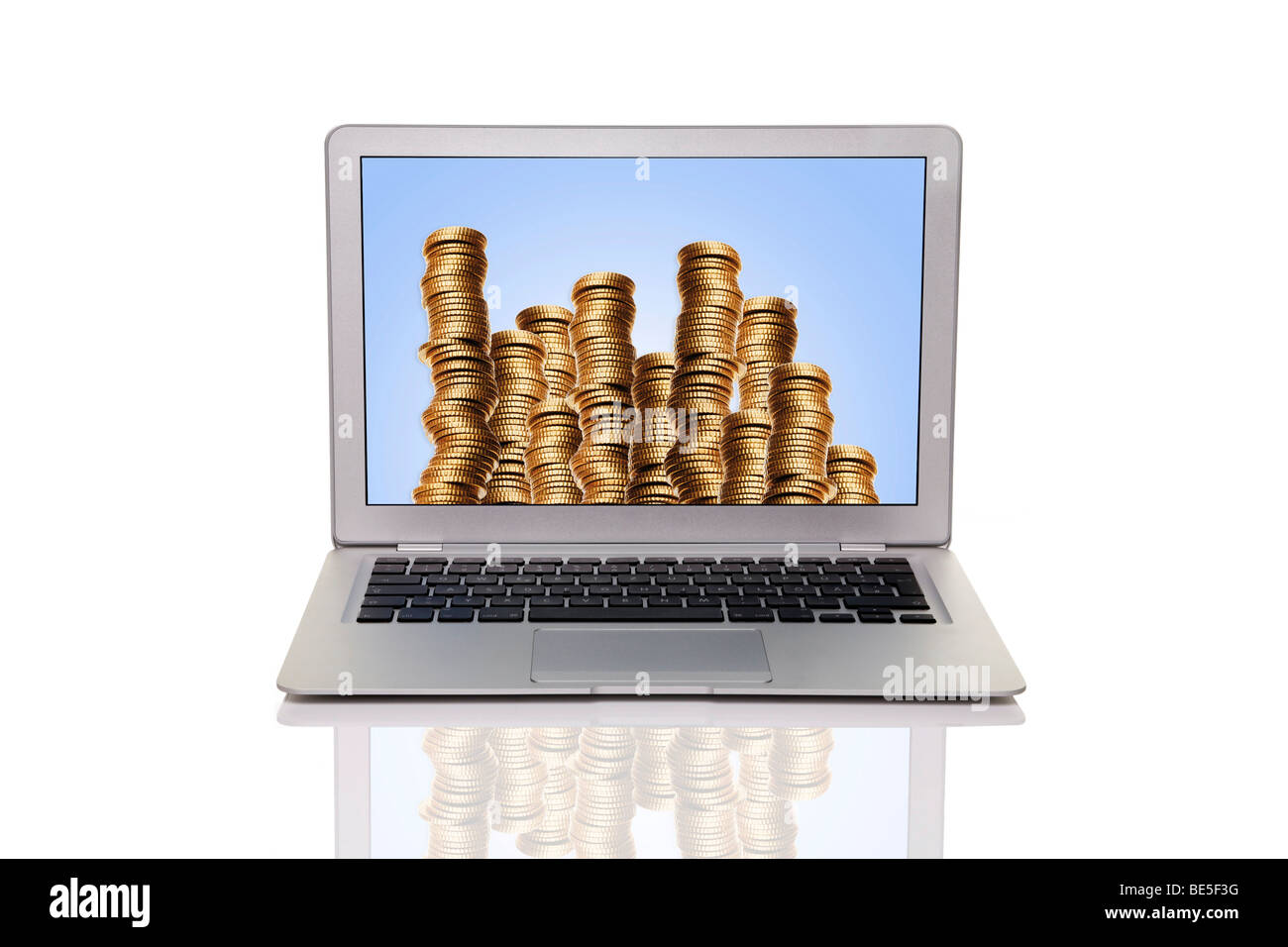 Laptop with a pile of money Stock Photo