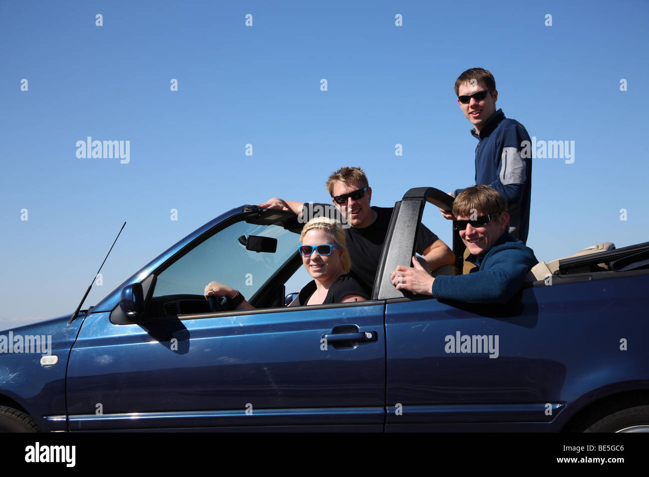 Group of young people in convertible car Stock Photo