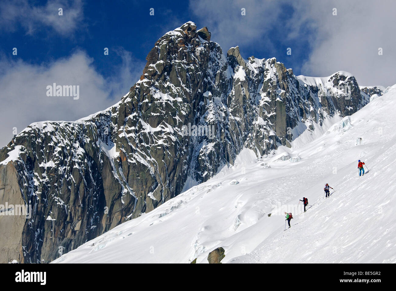 Touring skiers in a steep slope of the peak Le Petit Rognon in the Vallee Blanche, Haute-Savoie, France Stock Photo