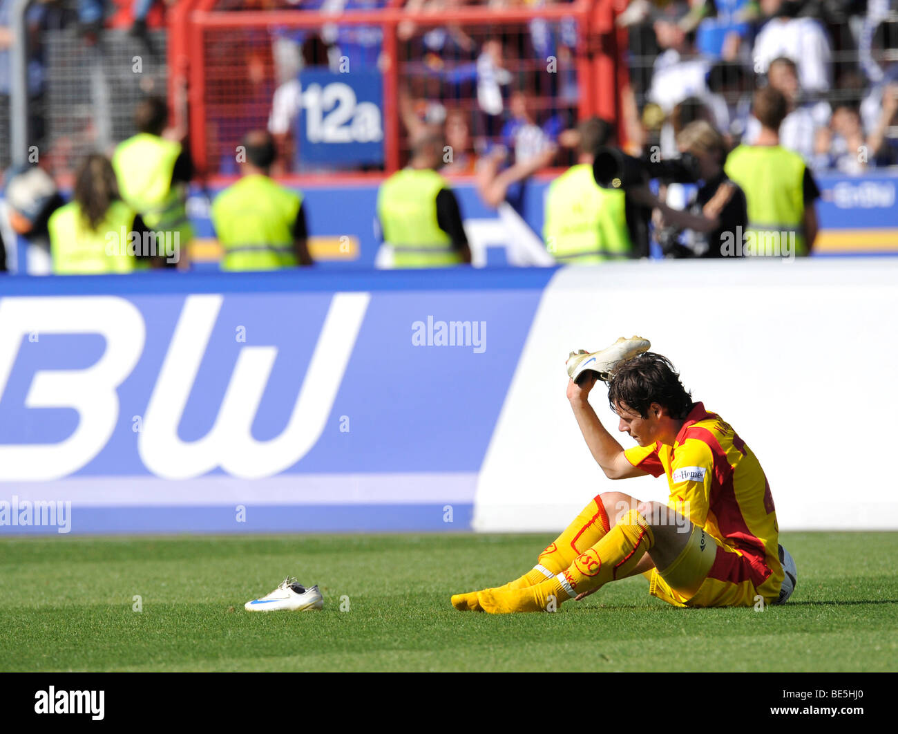 Disappointed Stefano Celozzi, Karlsruher SC, angrily hurling his shoes onto the lawn Stock Photo
