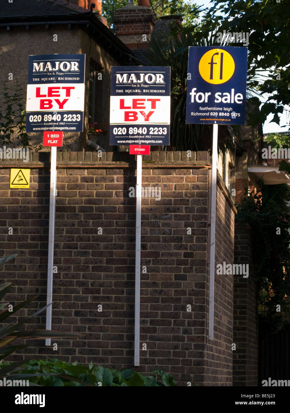 Estate agents' For Sale and For Let / Let By sign boards outside a