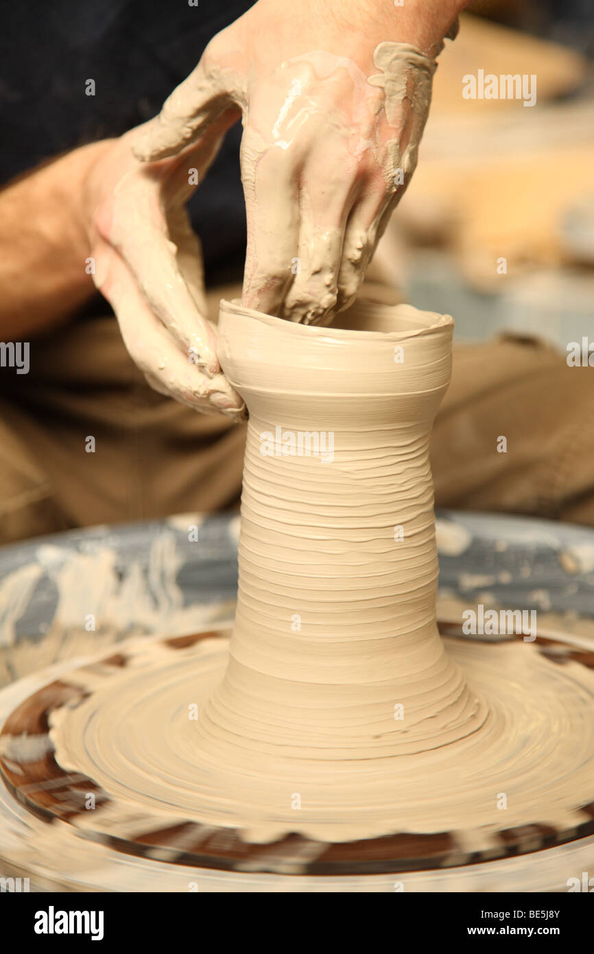 Closeup of hands shaping clay pottery Stock Photo