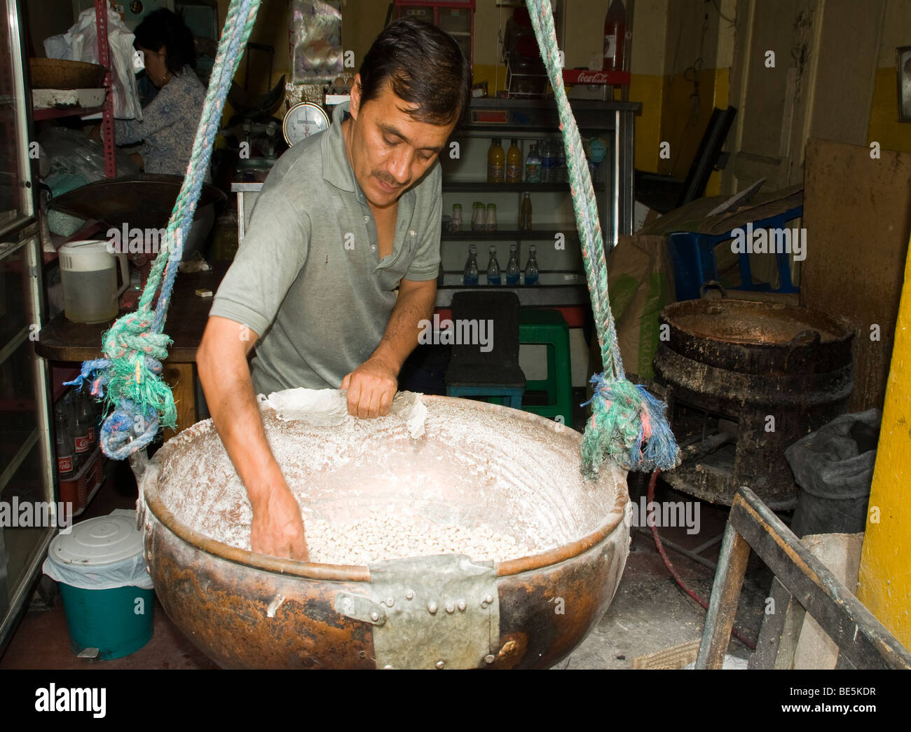 Ecuador. Quito. Traditional sweets. Craftsman making peanuts