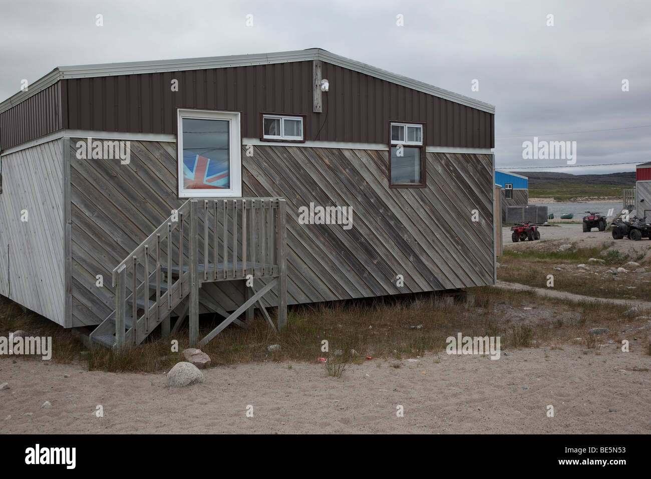 Wooden house and Union Jack at Inukjuak, Hudson Bay, Canada Stock Photo