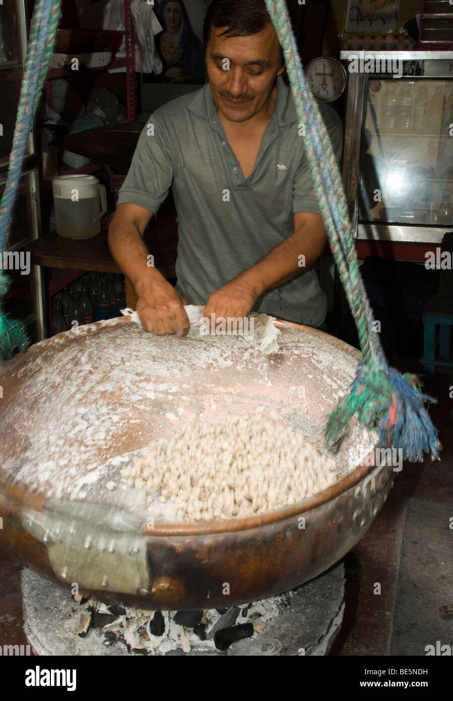 Ecuador. Quito. Traditional sweets. Craftsman making peanuts garrapiñadas. Stock Photo