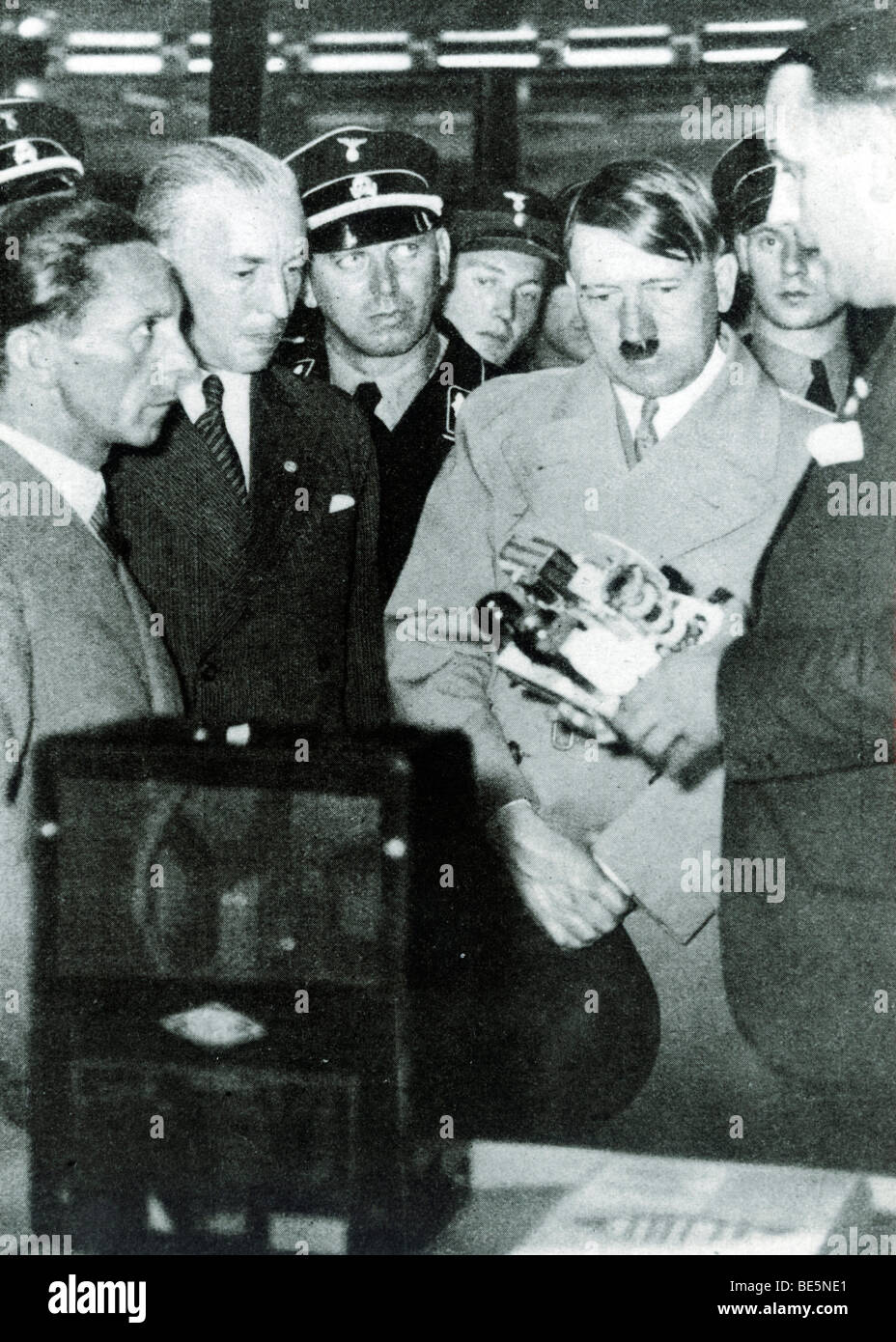 Josef Goebbels and Julius Schaub explain the Volksempfaenger radio to Adolf Hitler, historical photo circa 1936 Stock Photo