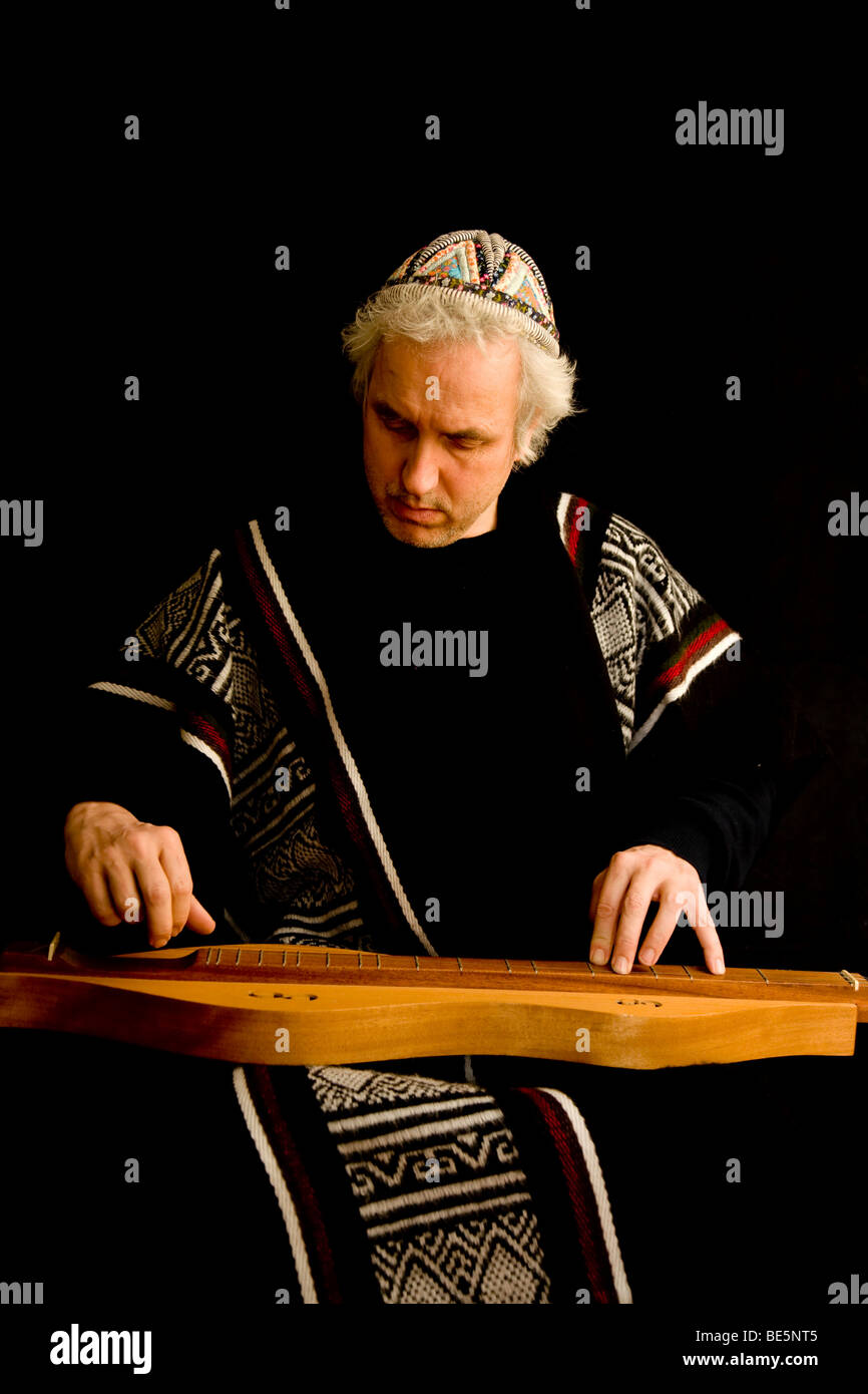 Musician in traditional costume playing the dulcimer Stock Photo Alamy