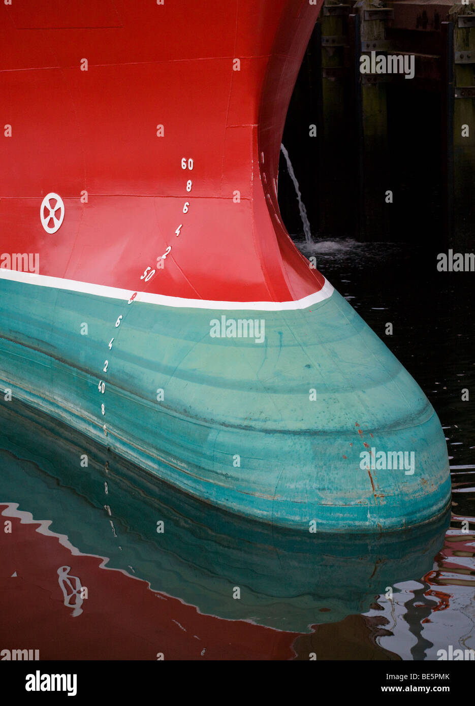 Bull Nose of a Deep Sea Fishing Trawler. A light load exposes the bull nosed prow of a large trawler red above and green below Stock Photo