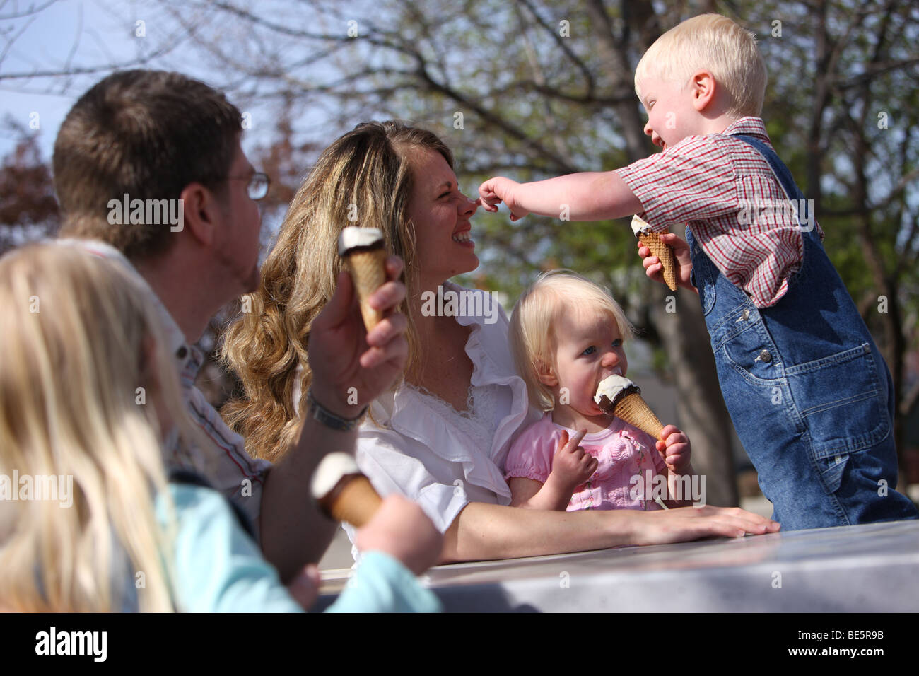 Family having ice cream cones together at park Stock Photo