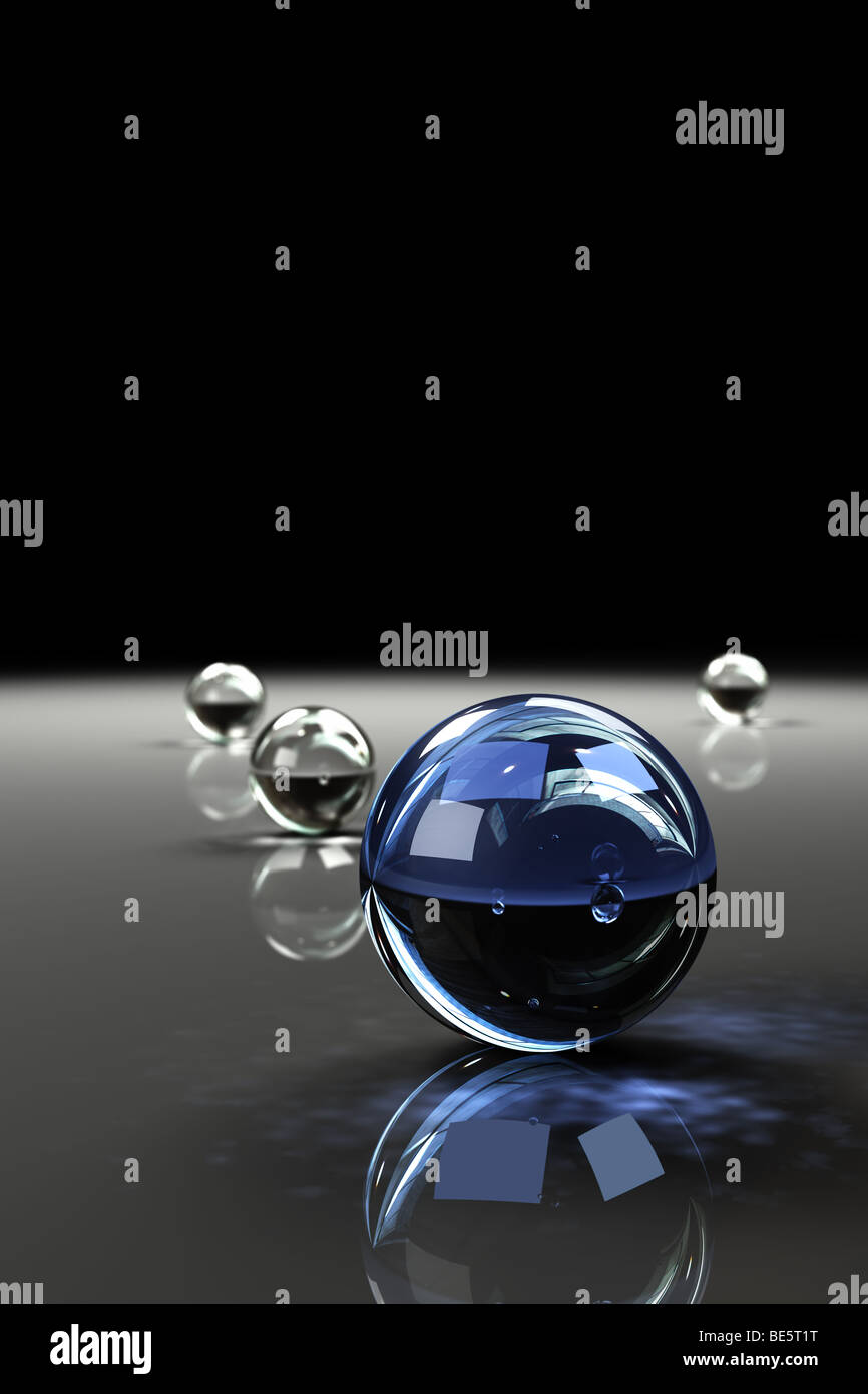 Glass marbles on glossy surface with reflections Stock Photo