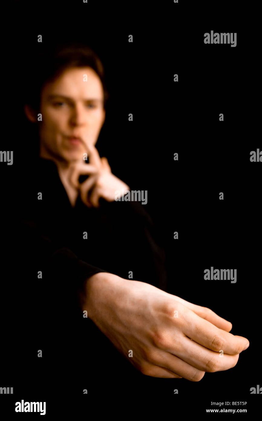 Studio shot young man imitates hi-res stock photography and images - Alamy