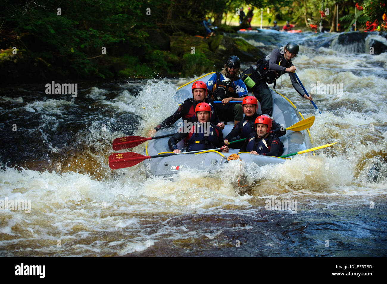 A Group of people white water rafting on the Tryweryn river, National White Water Centre, near Bala Gwynedd north wales UK Stock Photo