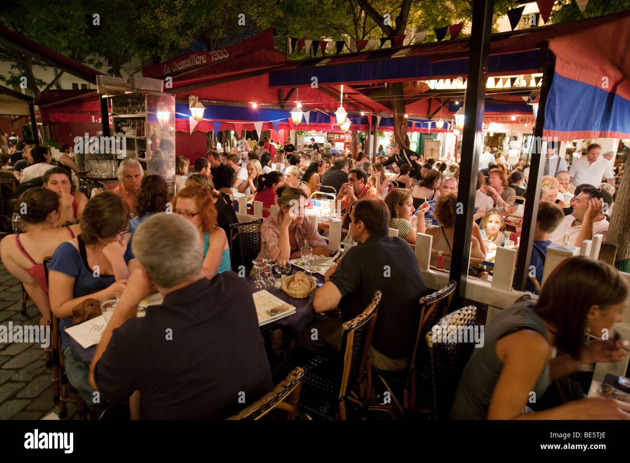 Diners in a Montmartre restaurant on a summers evening, Montmartre, Paris, France Stock Photo