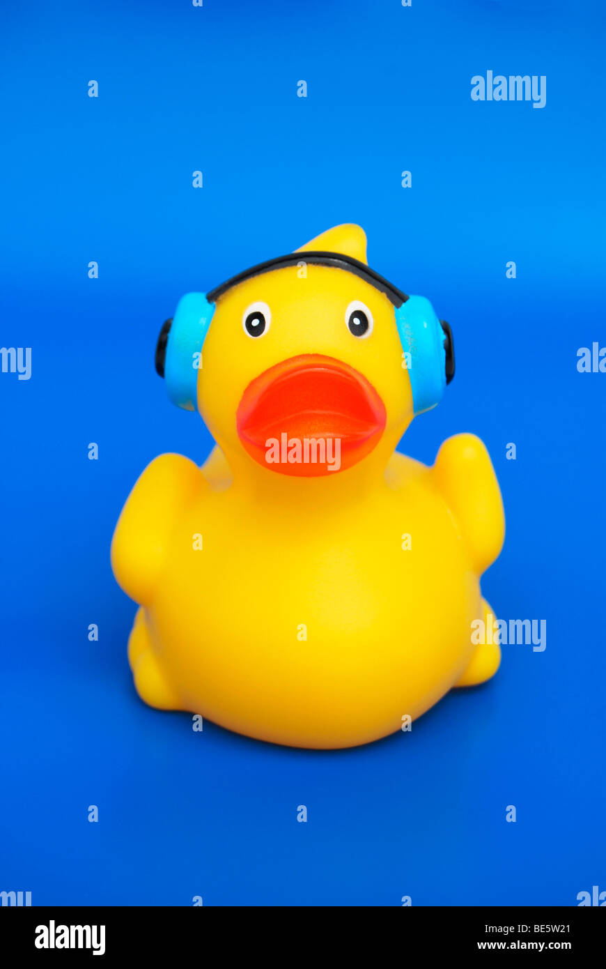 Yellow rubber duck with headphones, symbolic image for music, noise, acoustics, better hearing Stock Photo