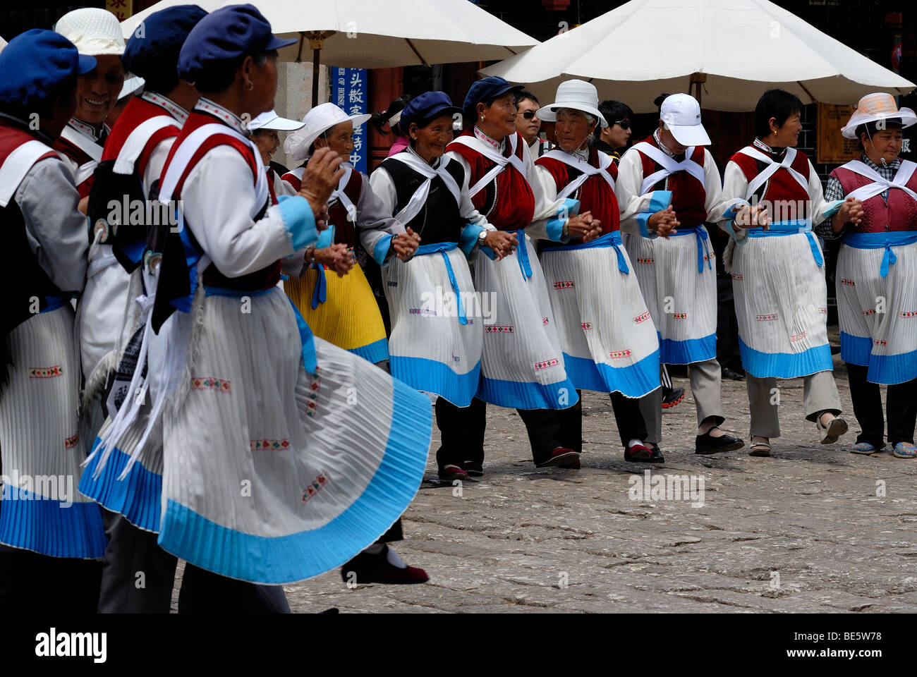 Elderly women of the Naxi minority in Naxi folk costume performing public folkdance, Lijiang, Yunnan, South China, China, Asia Stock Photo