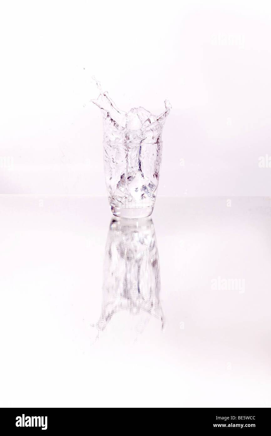 Ice cube falling into a Martini glass Stock Photo