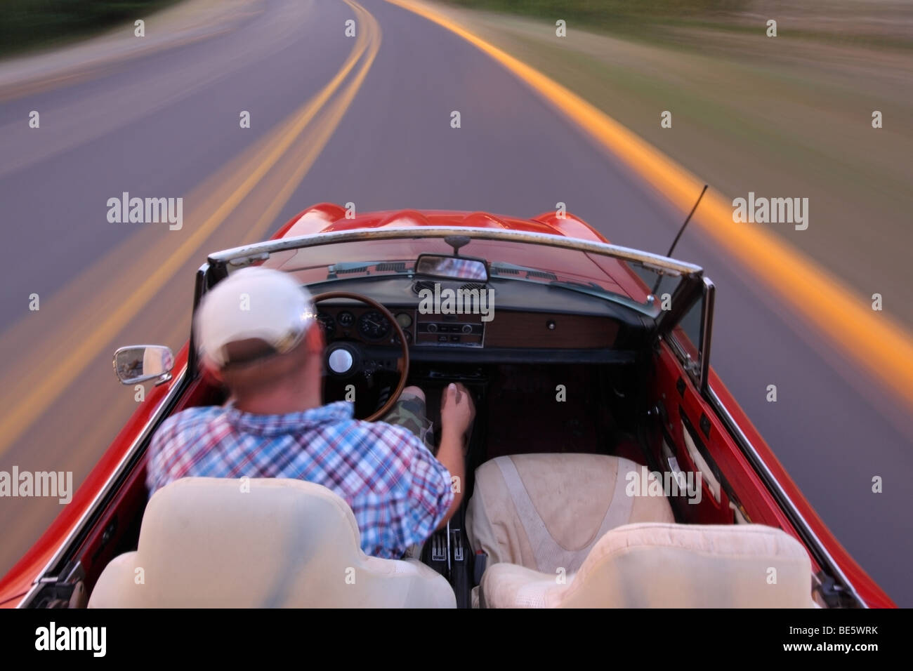 Blurred motion shot of man driving convertible Stock Photo