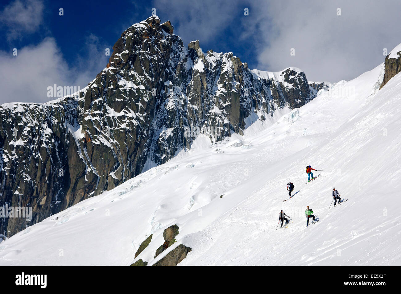 Touring skiers in a steep slope of the peak Le Petit Rognon in the Vallee Blanche, Haute-Savoie, France Stock Photo