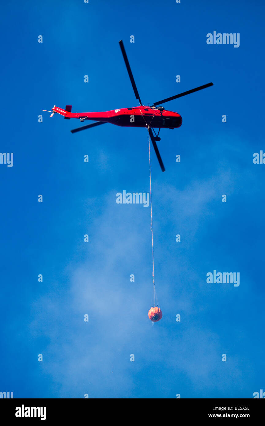 Helicopter air tanker dropping retardant at California  Lockheed wildfire in Santa Cruz Mountains Stock Photo