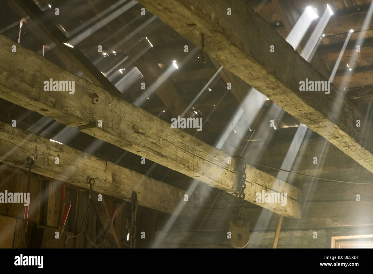 Beams of like in an old barn Stock Photo Alamy