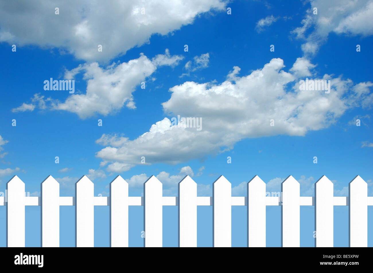 White fence in front of blue sky with clouds Stock Photo - Alamy