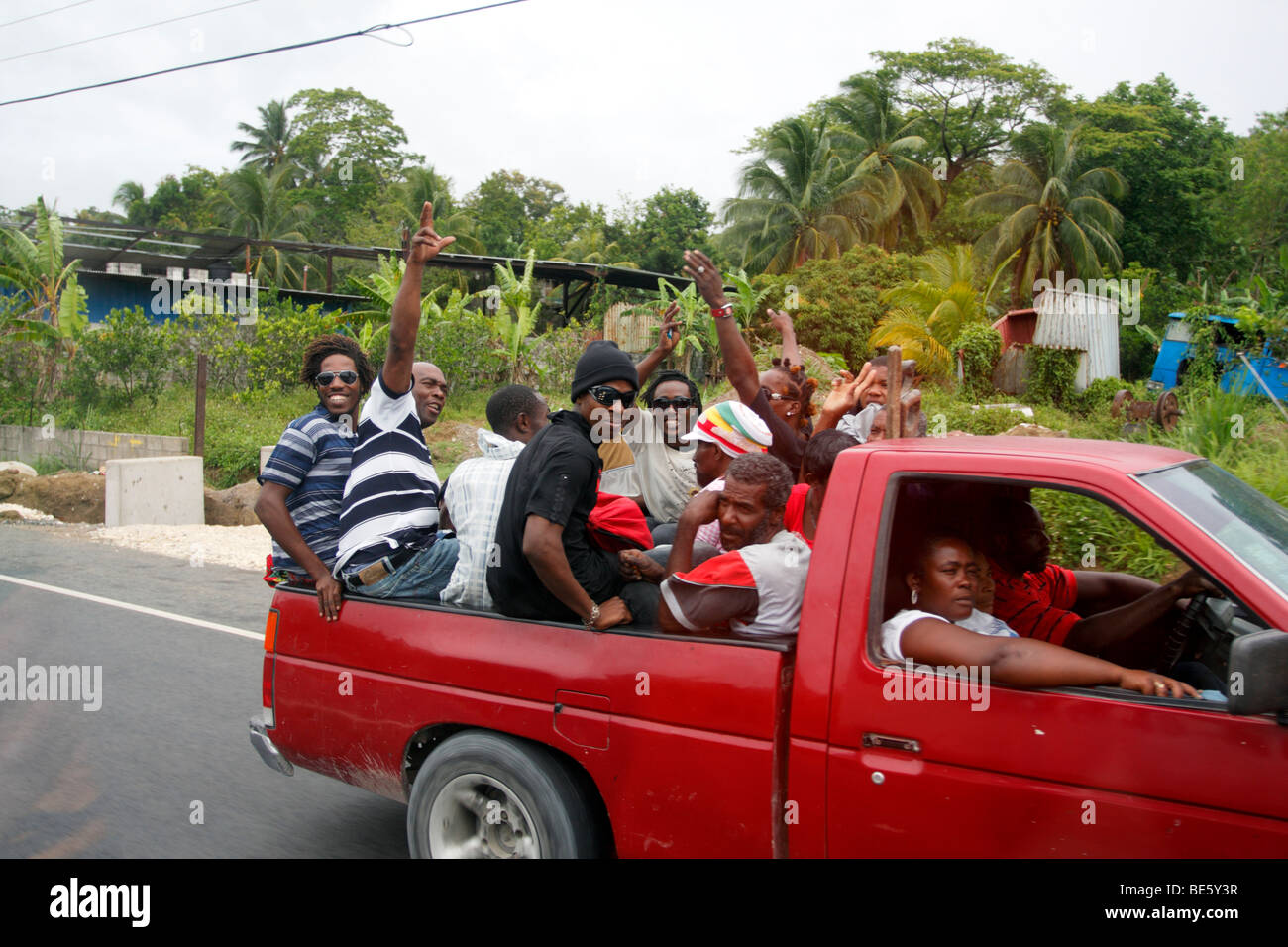 Truckload of Jamaican commuters traveling on a highway at approximately