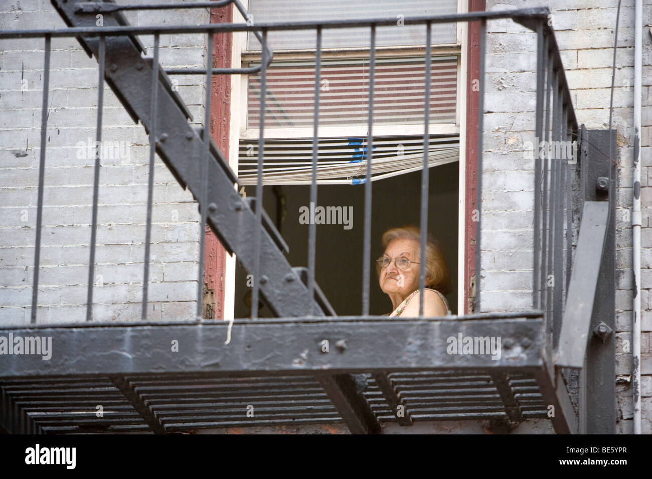 Woman Looking Out Her Apartment Window Lower East Side New York Usa ...
