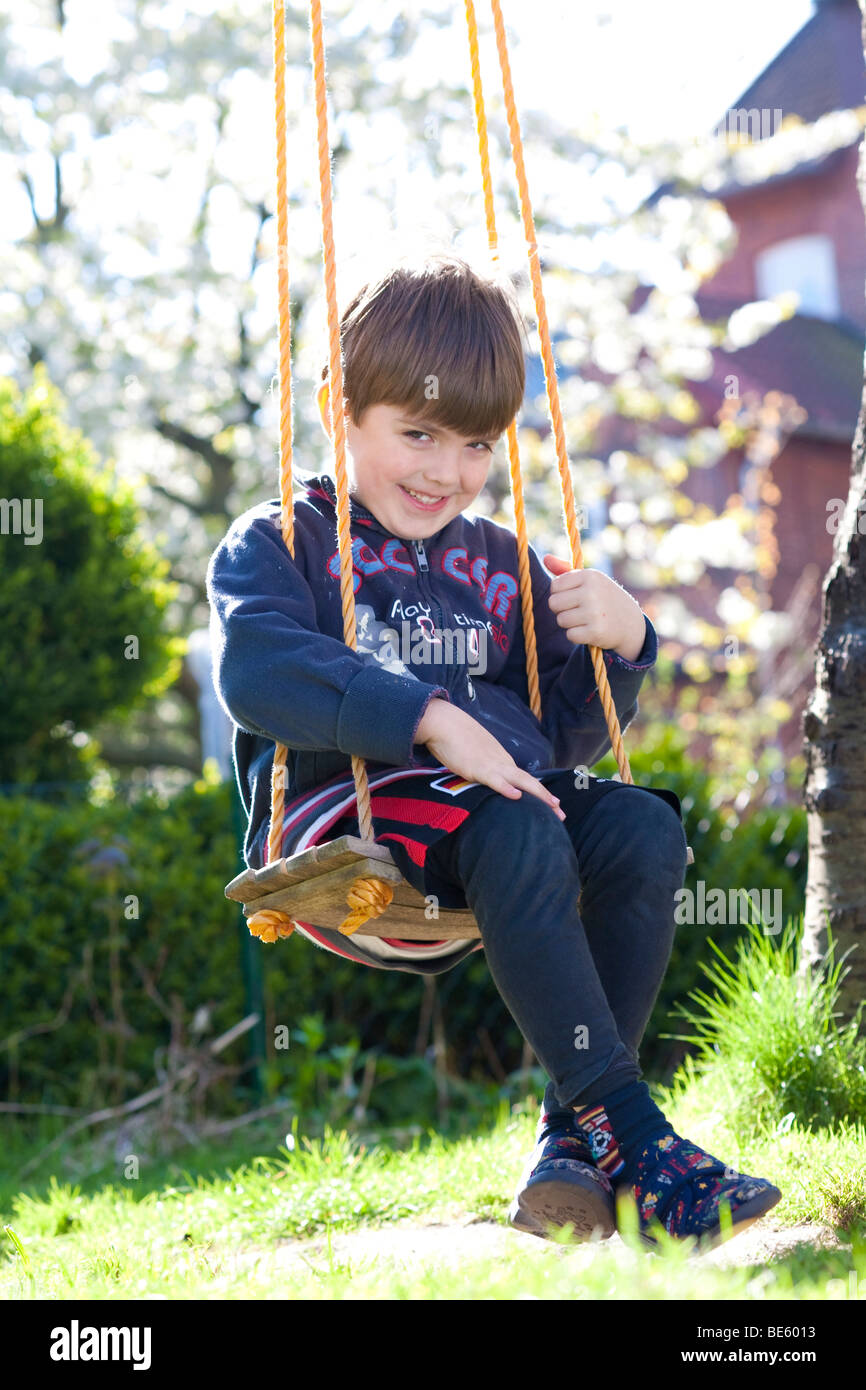 Boy on a garden swing Stock Photo