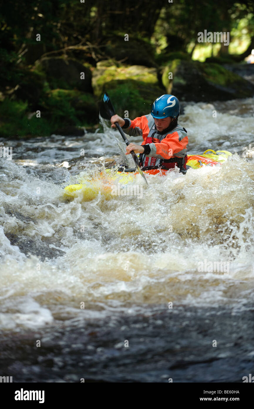 A person kayaking on the Tryweryn river, National White Water Centre, canoing watersports near Bala Gwynedd north wales UK Stock Photo