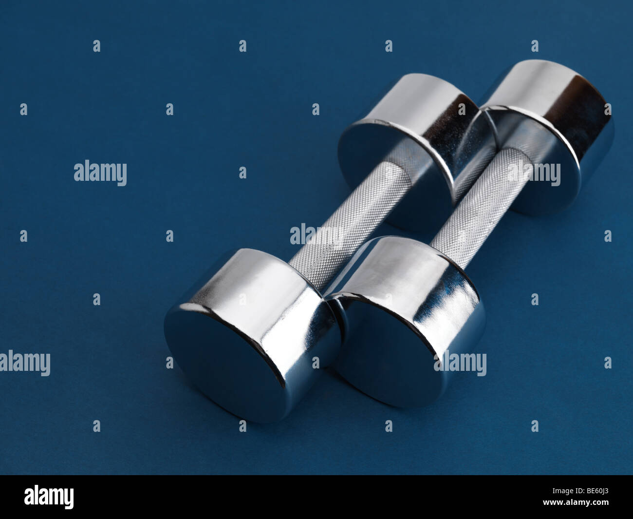 Shiny chrome plated fitness dumbbells Stock Photo