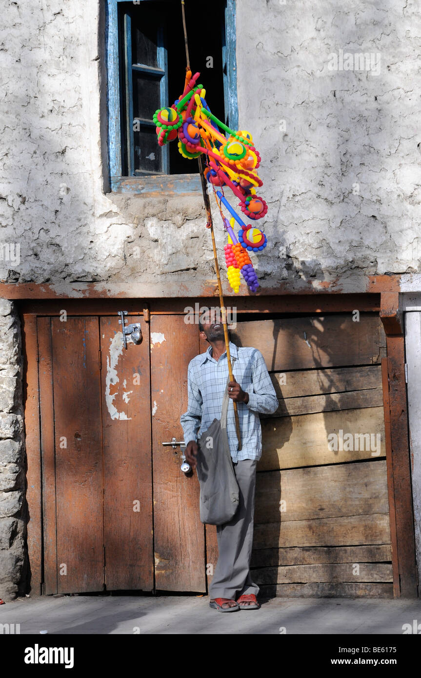 Indian from the lowerlands sells balloons in the old town of Leh, Ladakh, India, North India, Himalayas, Asia Stock Photo