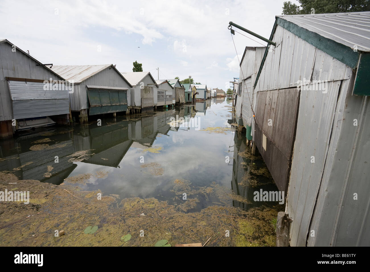 Boat Houses at Long Point. A double row of worn boathouses lines a channel in this small lake Erie community Stock Photo