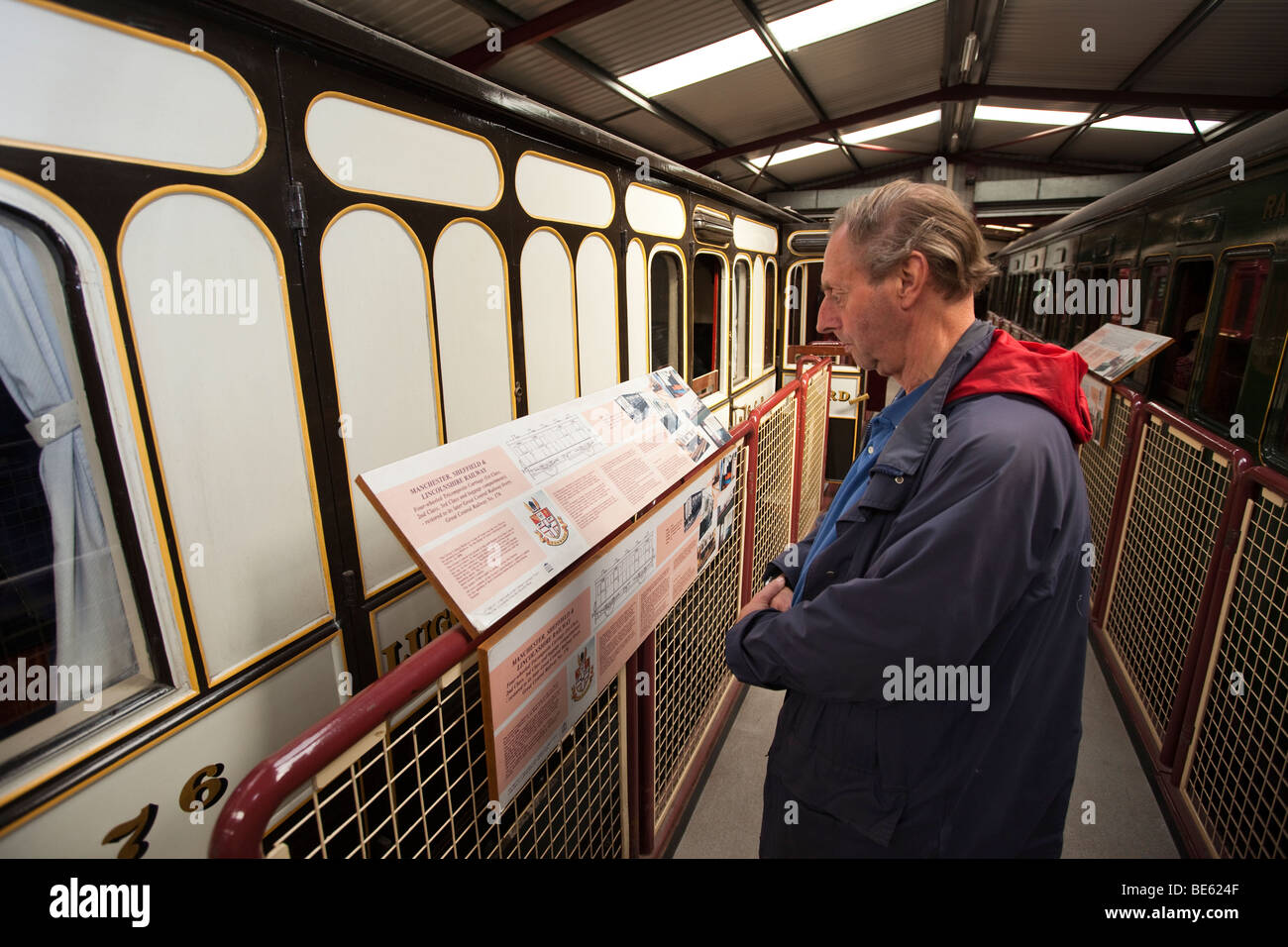 UK, England, Yorkshire, Keighley, Ingrow Museum of Rail Travel, man looking at vintage railway carriages display Stock Photo