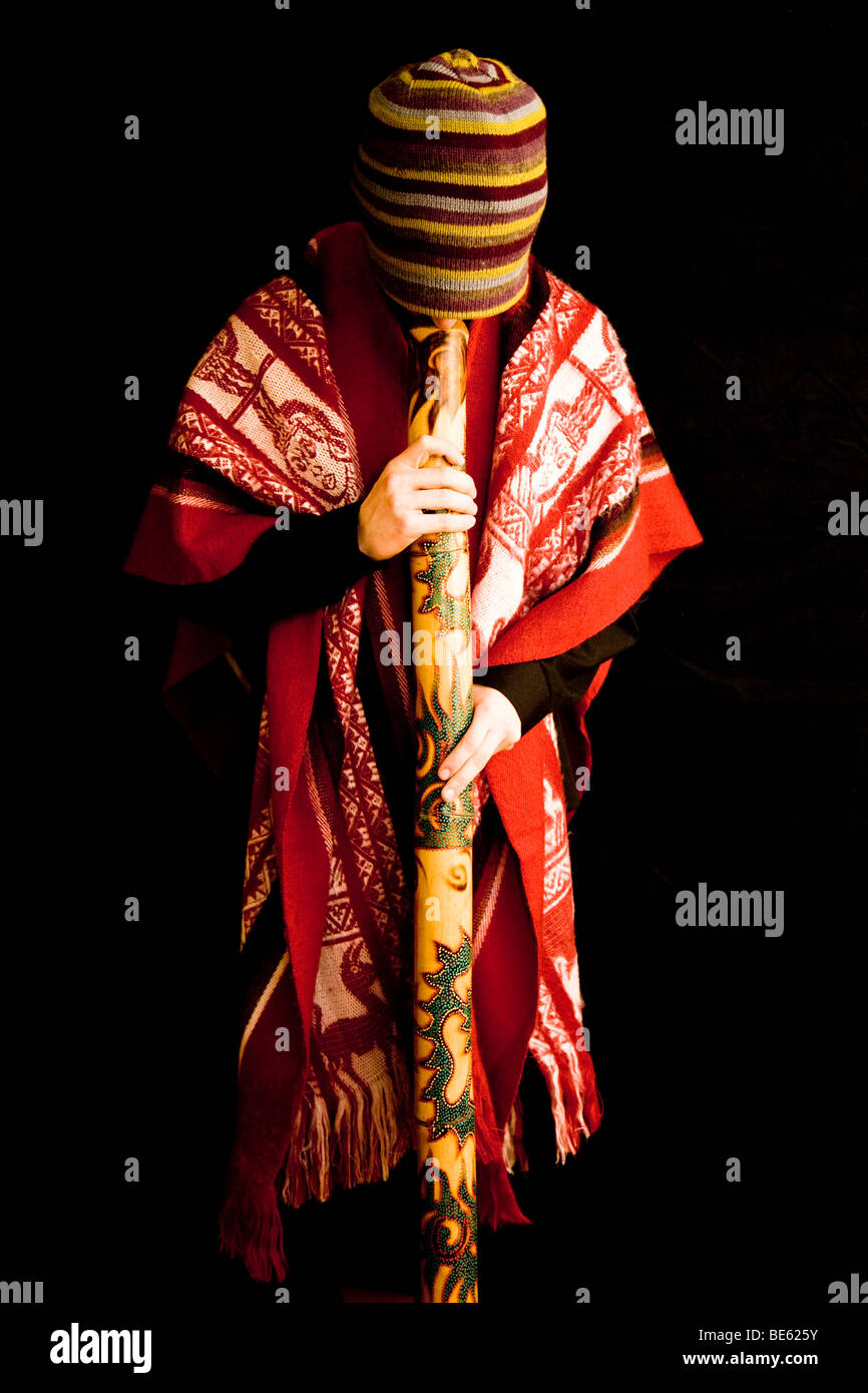 Young musician in traditional costume playing the didgeridoo Stock