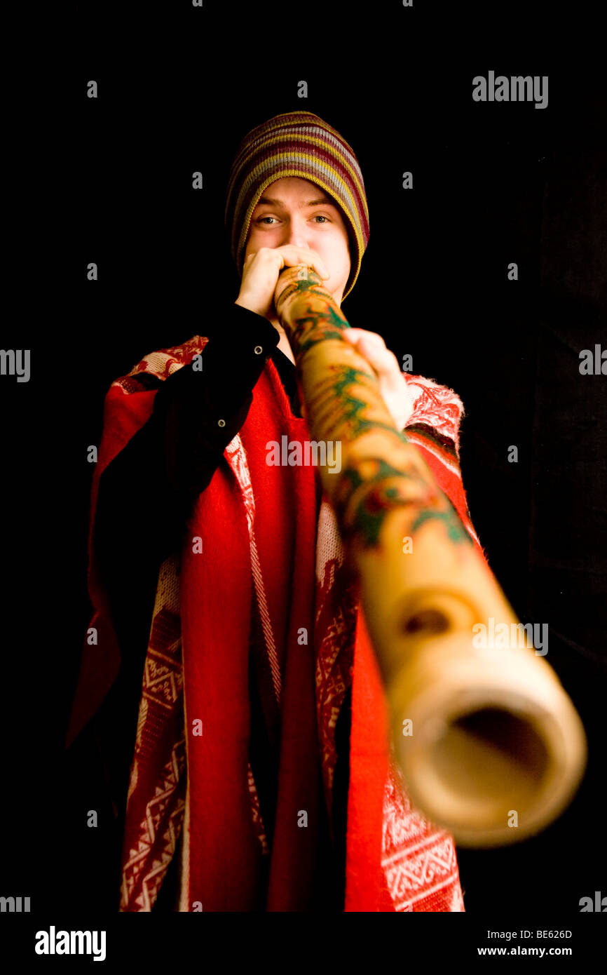 Young musician in traditional costume playing the didgeridoo Stock