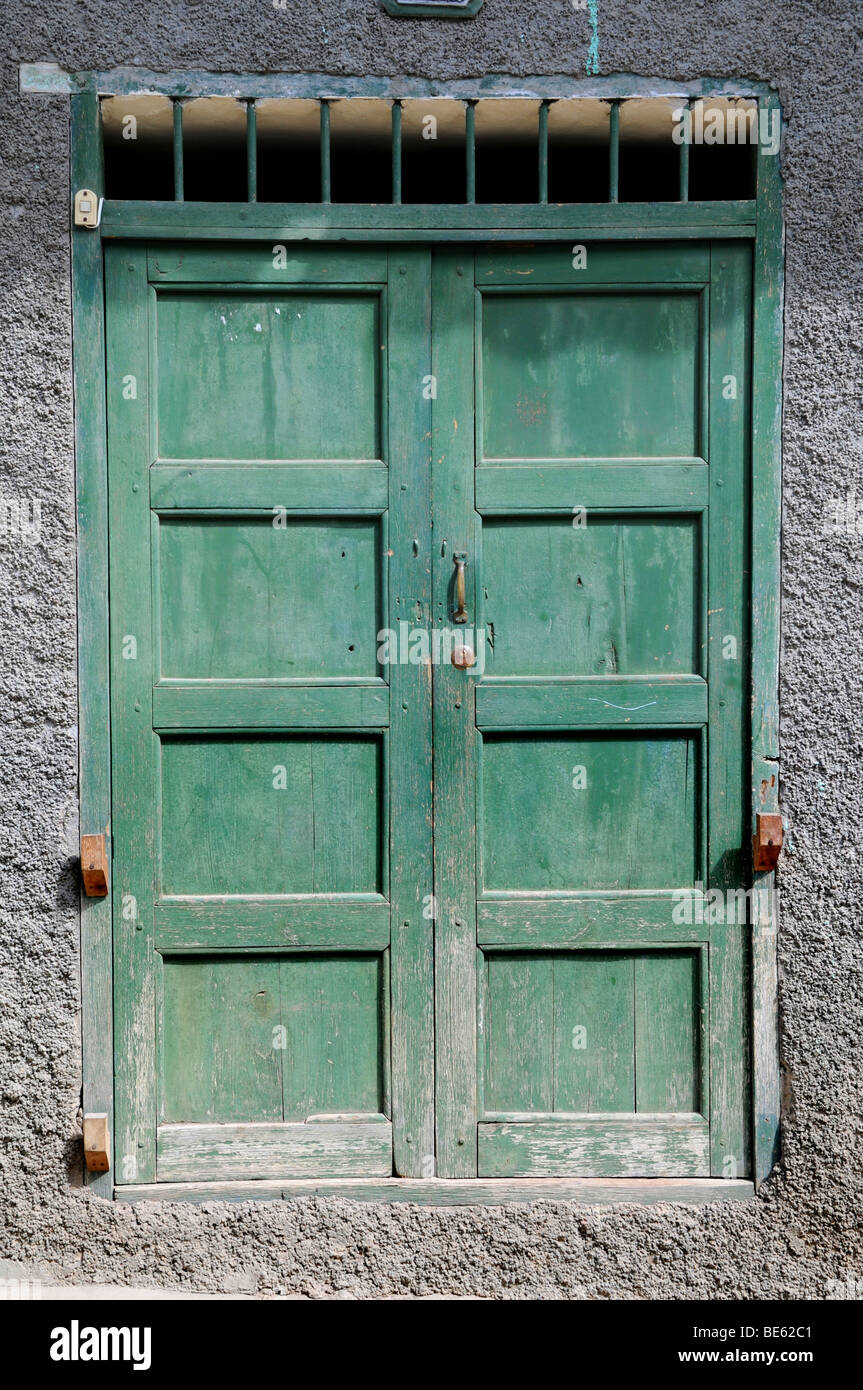 Old grunge green door with paint chipping in Cajabamba, Peru Stock Photo