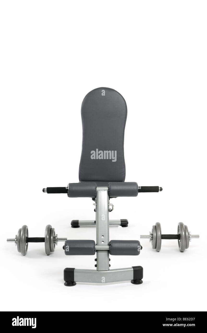 Exercise bench and dumbbells Stock Photo