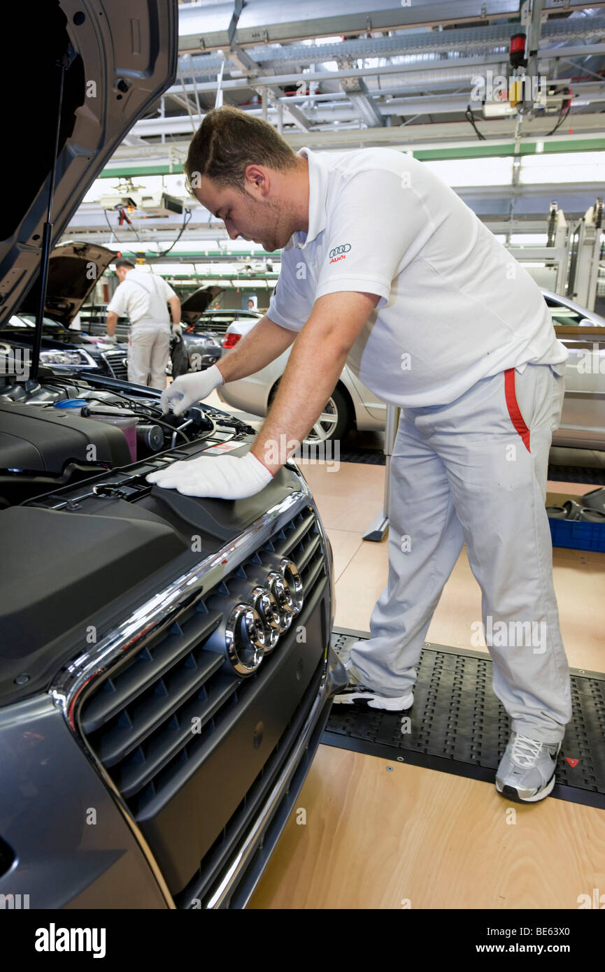 An Audi employee is checking an Audi A4 sedan for possible faults at the control centre of the Audi plant in Neckarsulm, Baden- Stock Photo