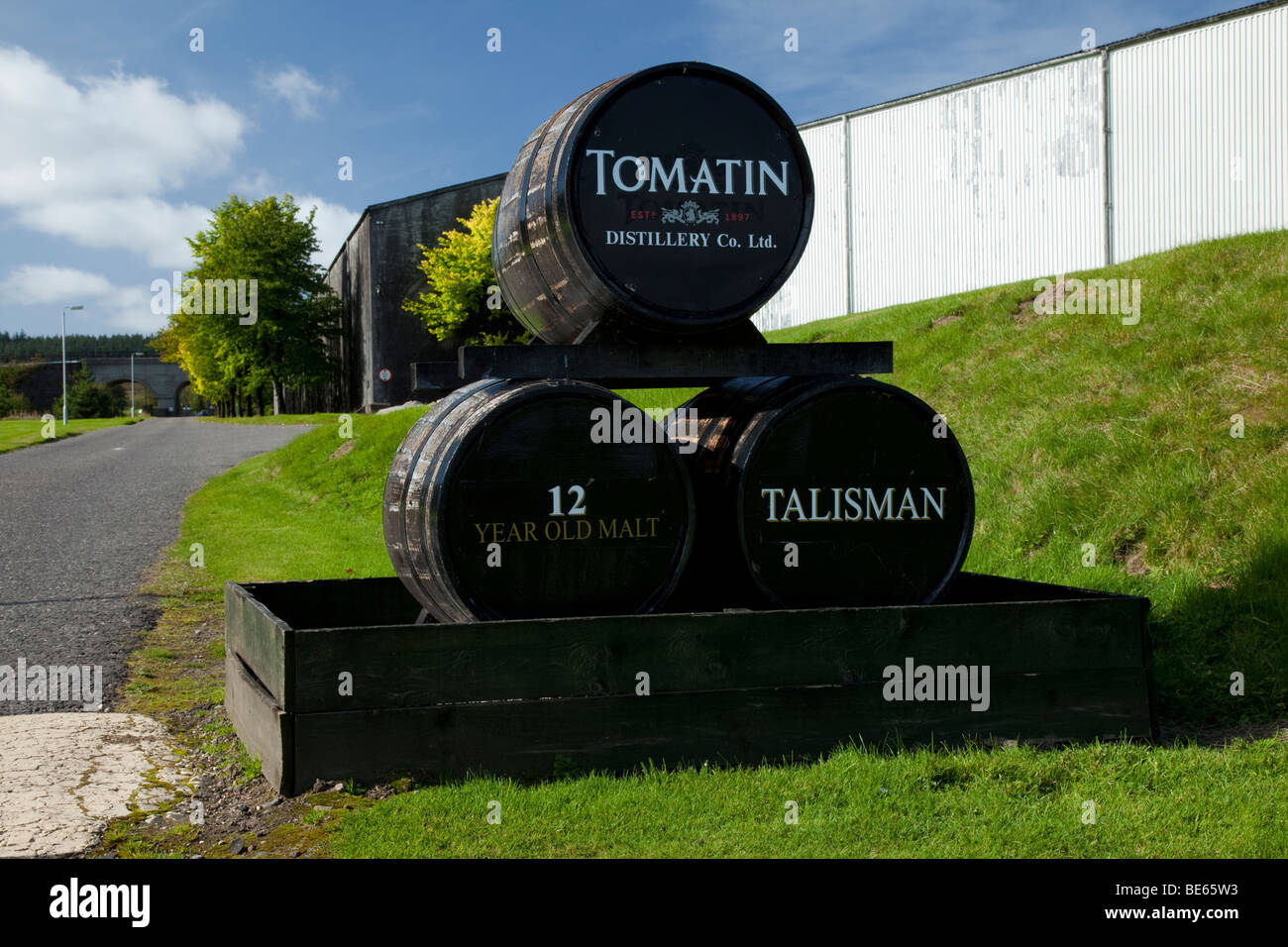 Whisky barrels showing Tomatin and Talisman Whisky Distillery outside the the Speyside Distillery at Tomatin in the Scottish Highlands, Scotland, UK Stock Photo