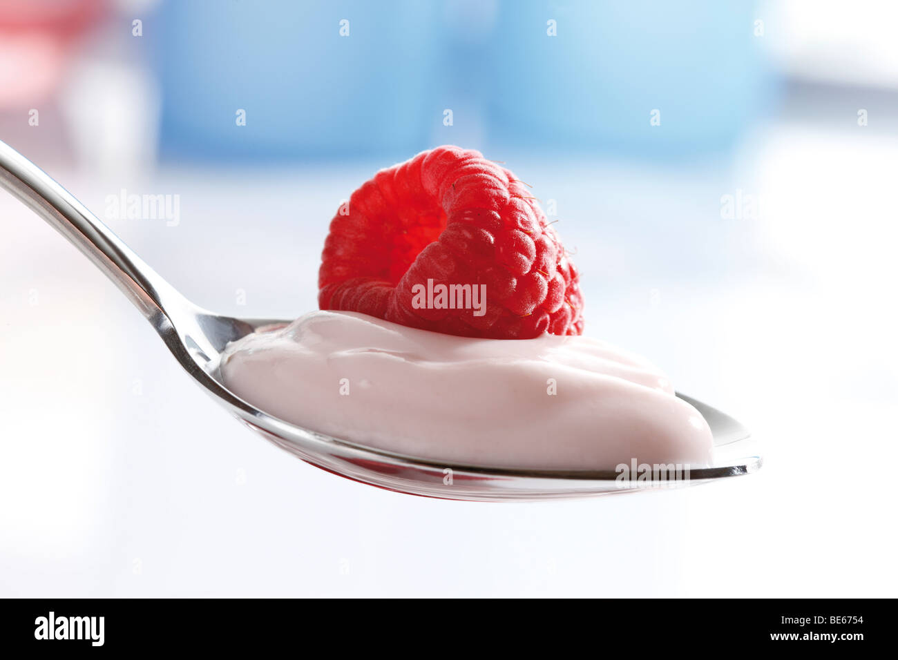 Raspberry yogurt on a spoon Stock Photo Alamy
