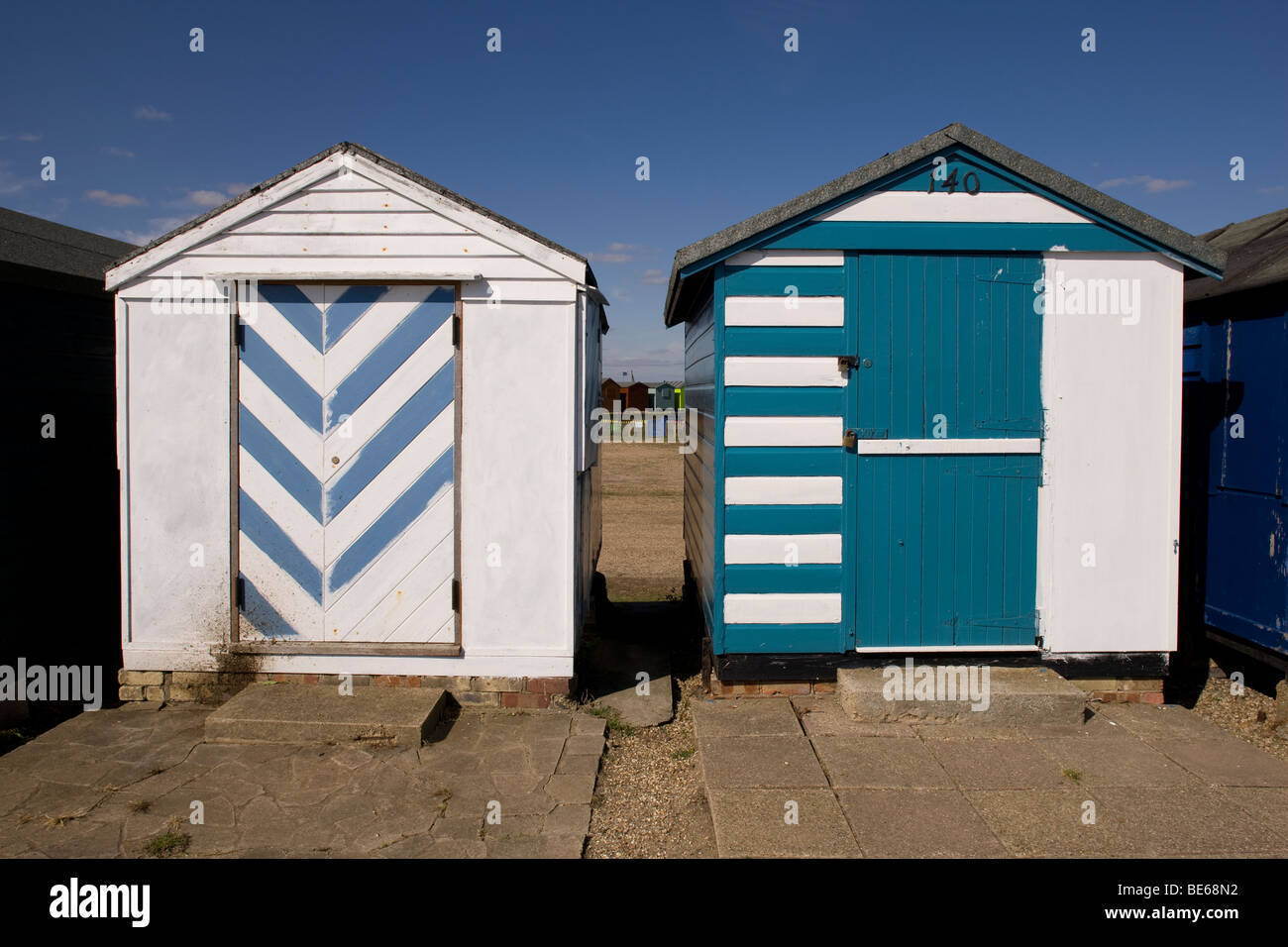 Brightly painted beach huts on the sea front of  the Essex coastal town of Brightlingsea are the star attraction of resort Stock Photo